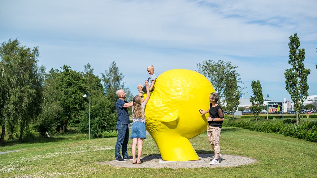 Visitors beside a sculpture in Billund Sculpture Park